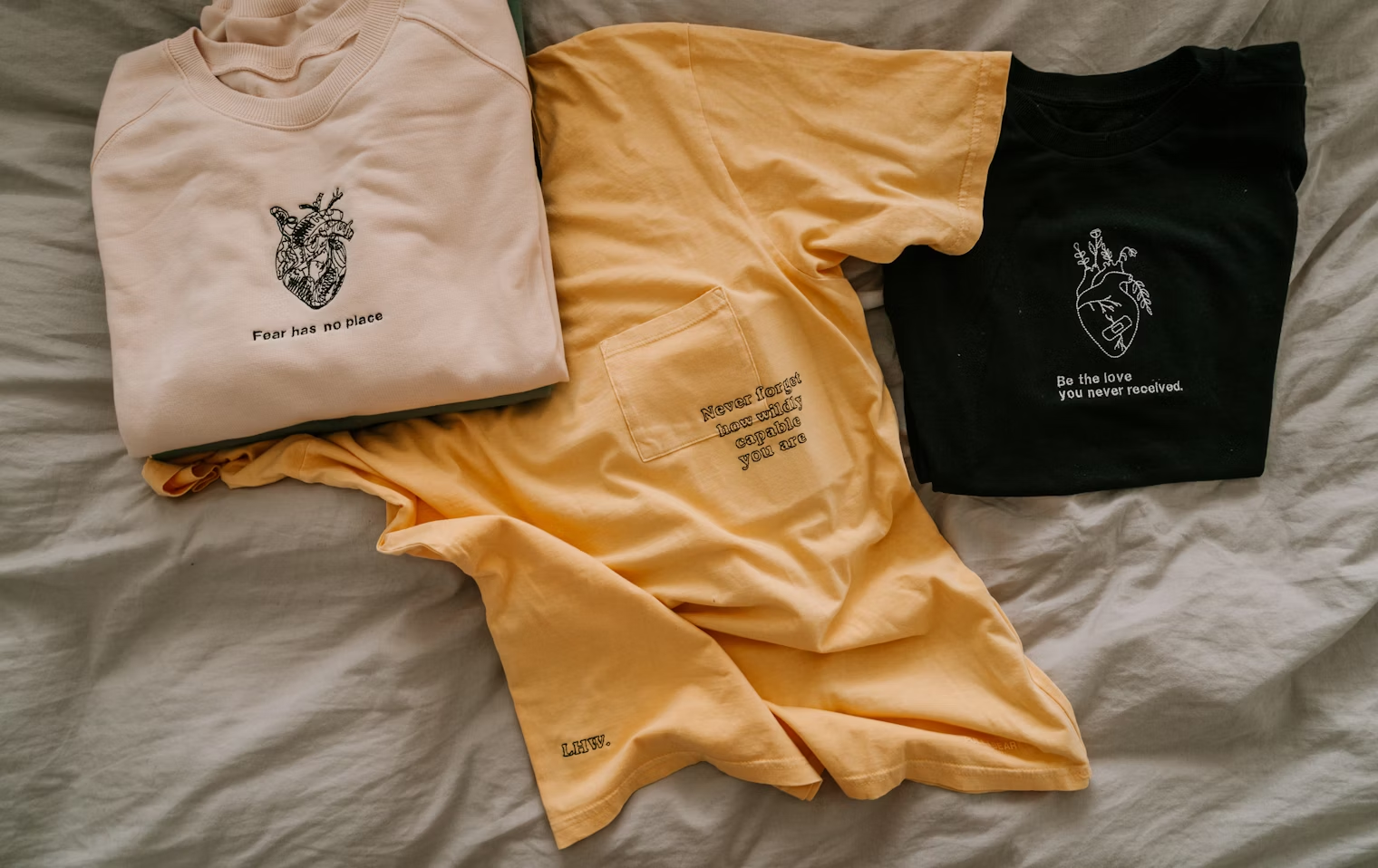 Studio flatlay of tees and cap